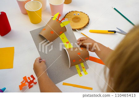 Step by step diy process. Homemade giraffe applique from a paper cup. Kids craft giraffe from a paper coffee cup, zero waste concept. Step by step diy process. Homemade giraffe applique from a paper cup. Kids craft giraffe from a paper coffee cup, zero waste concept. 110465413