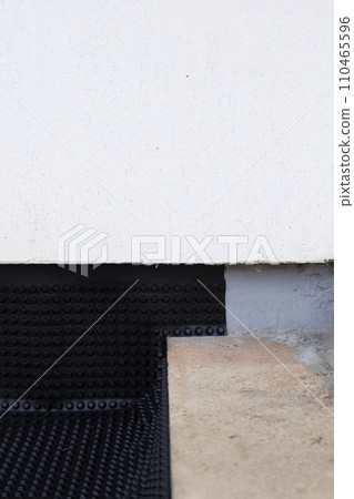 Construction of a country house. Draining water from the foundation of the house, using a waterproofing membrane. 110465596