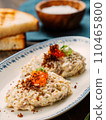 Fish appetizer forshmak - minced meat from herring fish, decorated caviar on plate. Traditional Jewish cuisine dish vorschmack forshmak made of herring fillet as independent dish on wooden background 110465800