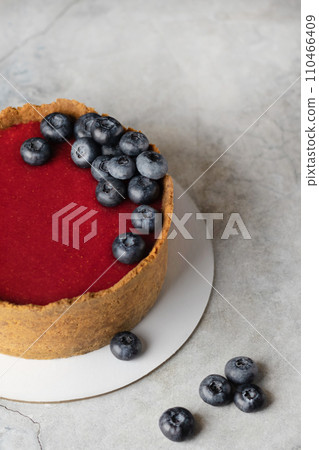 Classic New York cheesecake with strawberry jam decorated with blueberries close up copy space 110466409
