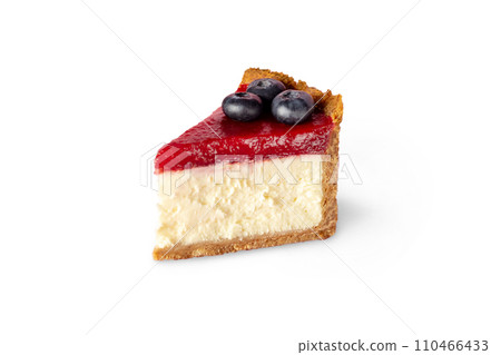 Piece of Classic New York cheesecake with strawberry jam decorated with blueberries close up isolated photo on white Piece of Classic New York cheesecake with strawberry jam decorated with blueberries close up isolated photo on white 110466433
