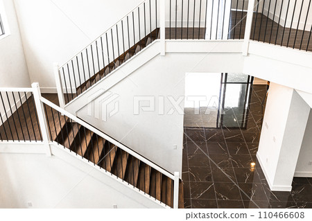Modern white wooden staircase in new house interior with big windows Modern white wooden staircase in new house interior with big windows 110466608