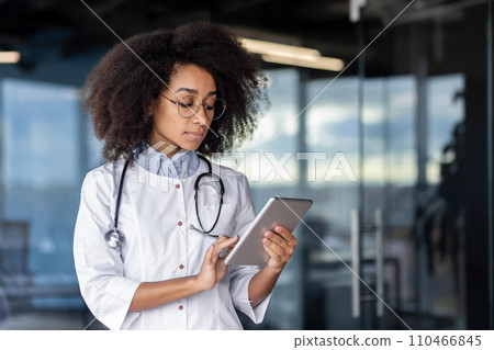 Healthcare woman doctor specialist with a digital tablet provides expert advice and care to patient. Using technology for communication, diagnosis, ensures of service and healthcare outcomes 110466845