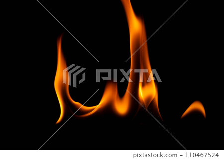 Hot flames on a black background. Beautiful flame of fire in the dark. Abstract of burning flames and smoke. Hot flames on a black background. Beautiful flame of fire in the dark. Abstract of burning flames and smoke. 110467524