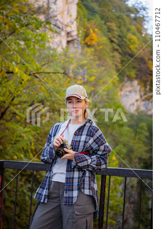 Girl taking pictures of a mountain gorge Girl taking pictures of a mountain gorge 110467712