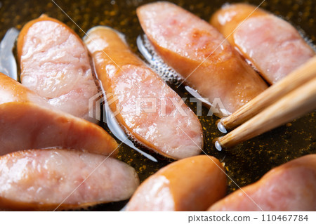 A cooking scene where sausages are simmered in soup stock to make eggs. A cooking scene where sausages are simmered in soup stock to make eggs. 110467784
