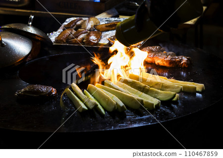 Cooking sausages and grilled vegetables over a campfire. Recreation and summer camping in the countryside. Night Cooking sausages and grilled vegetables over a campfire. Recreation and summer camping in the countryside. Night 110467859