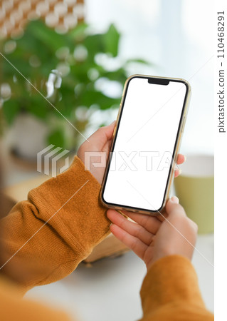 Closeup woman hands holding mobile phone with empty screen for advertising or message 110468291