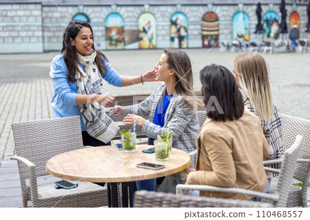Joyful Reunion at an Outdoor Cafe 110468557