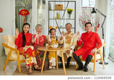 Family members wearing traditional costumers when celebrating Tet at home Family members wearing traditional costumers when celebrating Tet at home 110469509