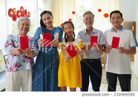 Happy three generation family showing lucky money envelopes, as traditional gift for Tet 110469560