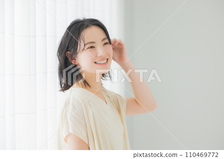 A young woman basking in the morning sunlight A young woman basking in the morning sunlight 110469772