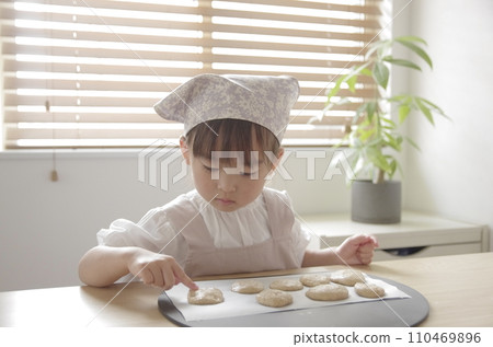 A girl crazy about making cookies in the living room A girl crazy about making cookies in the living room 110469896