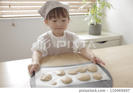 A girl crazy about making cookies in the living room A girl crazy about making cookies in the living room 110469897