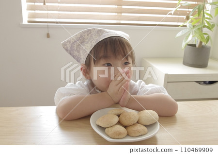 A girl crazy about making cookies in the living room 110469909