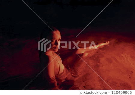 Elegant lady submerged in a serene lagoon during nocturnal hours, displaying grace, allure amidst water. Female embodies natural beauty, tranquility in aquatic setting. Art night photography. Elegant lady submerged in a serene lagoon during nocturnal hours, displaying grace, allure amidst water. Female embodies natural beauty, tranquility in aquatic setting. Art night photography. 110469966