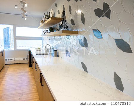 A compact bar area within a hotel's fitness center, featuring a striking geometric backsplash and floating wooden shelves, with a panoramic window offering views of the urban skyline. A compact bar area within a hotel's fitness center, featuring a striking geometric backsplash and floating wooden shelves, with a panoramic window offering views of the urban skyline. 110470513