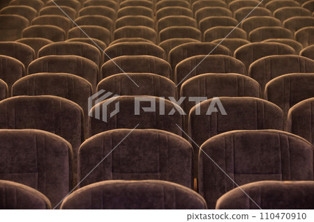 Brown soft comfortable chairs are empty in the auditorium or concert hall. 110470910
