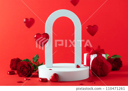 Abstract empty white podium with arch, hearts and rose flowers on red background 110471261