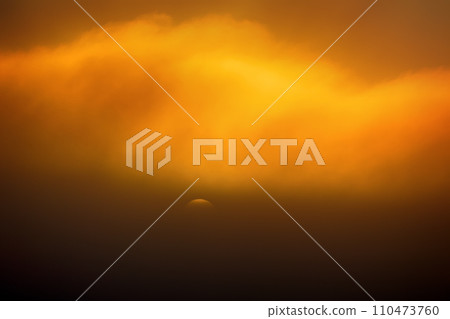 setting sun in the misty haze 110473760