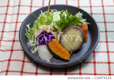 Steamed vegetable salad on a plate with dressing Steamed vegetable salad on a plate with dressing 110474120