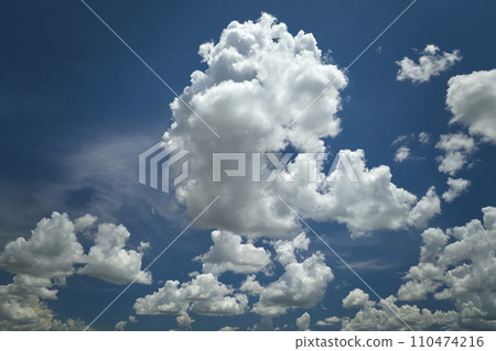 White puffy cumulus clouds on summer blue sky White puffy cumulus clouds on summer blue sky 110474216