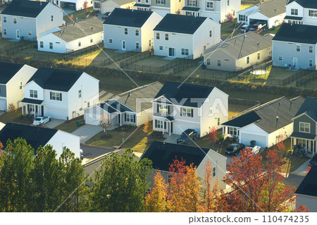 View from above of densely built residential houses in living area in South Carolina. American dream homes as example of real estate development in US suburbs View from above of densely built residential houses in living area in South Carolina. American dream homes as example of real estate development in US suburbs 110474235