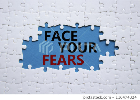 Face your Fears symbol. Concept words Face your Fears on white puzzle. Beautiful blue background. Business and Face your Fears. Copy space. 110474324