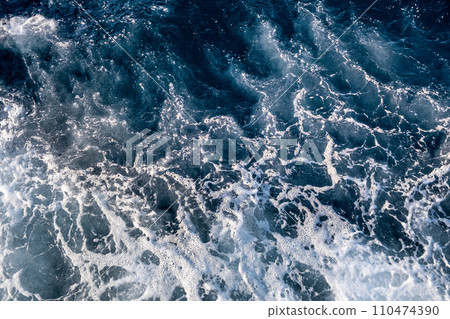 Top down aerial view of sea water surface. White foam waves texture as natural background. 110474390