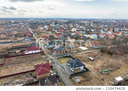 Residential houses with roof tops covered with metallic and ceramic shingles in rural suburban area 110474428