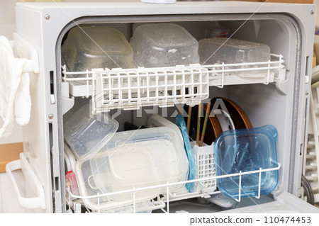 Dishwasher full of dishes 110474453