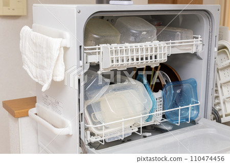 Dishwasher full of dishes 110474456