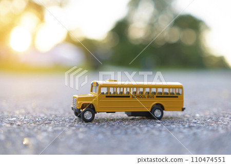 Model of classical american yellow school bus for transporting of kids to and from school every day. Concept of education in the USA 110474551
