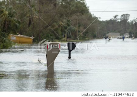 Hurricane flooded street with mail box surrounded with water in Florida residential area. Consequences of natural disaster Hurricane flooded street with mail box surrounded with water in Florida residential area. Consequences of natural disaster 110474638