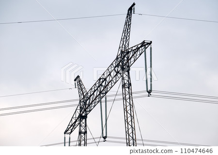 High voltage tower with electric power lines transfening electrical energy through cable wires 110474646