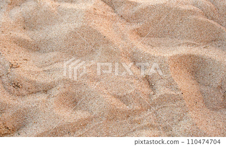 Flat view of clean yellow sand surface covering seaside beach. Sandy texture Flat view of clean yellow sand surface covering seaside beach. Sandy texture 110474704
