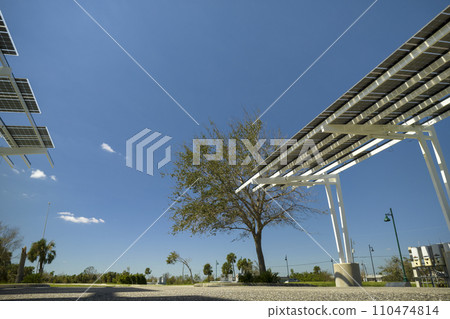 Destroyed by hurricane wind photovoltaic solar panels mounted on carport roof for producing green ecological electricity for electric vehicle charging. Consequences of natural disaster in Florida 110474814