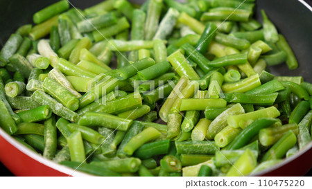 Green beans are being cooked in a pan, close up. Selective focus Green beans are being cooked in a pan, close up. Selective focus 110475220