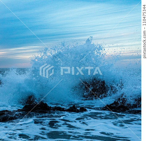 Rough waves breaking rocks Rough waves breaking rocks 110475344