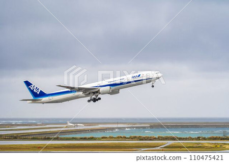 Rainy airport, plane taking off, Naha City, Okinawa Prefecture 110475421