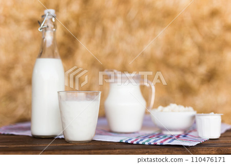 Dairy products on table against the background of hay 110476171