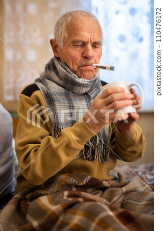 Elderly Senor Treated For Cold With Hot Tea At Home 110476172
