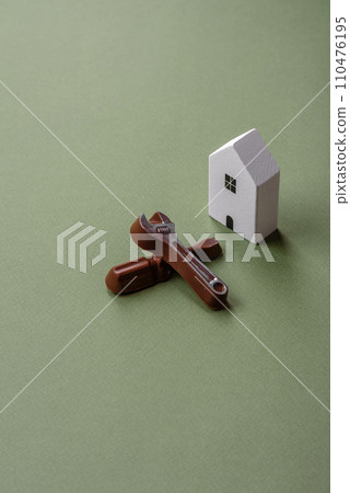 Repair or home improvement tools and a house model on a plain background Repair or home improvement tools and a house model on a plain background 110476195