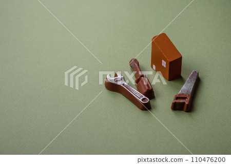 Repair or home improvement tools and a house model on a plain background Repair or home improvement tools and a house model on a plain background 110476200