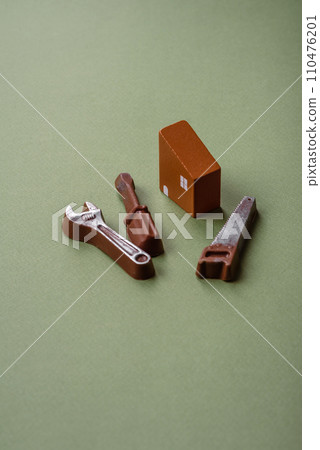 Repair or home improvement tools and a house model on a plain background Repair or home improvement tools and a house model on a plain background 110476201