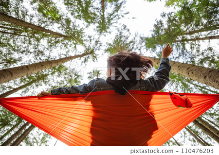 happy woman on hammock in the forest happy woman on hammock in the forest 110476203