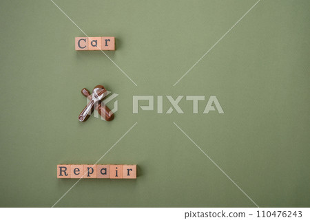 Tools and inscriptions symbolizing repairs or a garage and its attributes on a plain background Tools and inscriptions symbolizing repairs or a garage and its attributes on a plain background 110476243