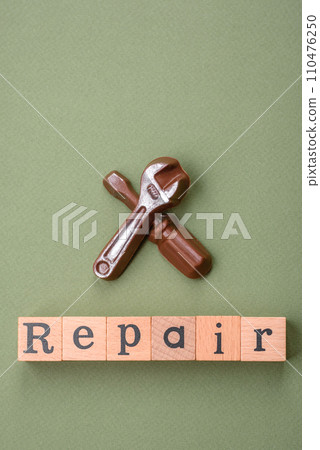 Tools and inscriptions symbolizing repairs or a garage and its attributes on a plain background 110476250