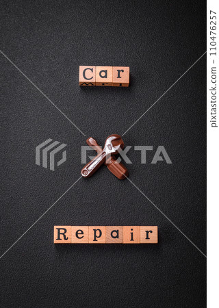 Tools and inscriptions symbolizing repairs or a garage and its attributes on a plain background Tools and inscriptions symbolizing repairs or a garage and its attributes on a plain background 110476257