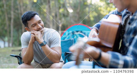Happy Asian male gay couple on camping together in a forest. romantic vocation trip. lgbt concept Happy Asian male gay couple on camping together in a forest. romantic vocation trip. lgbt concept 110476398